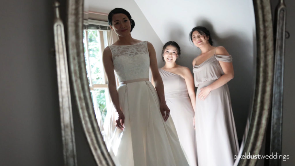 bride looks at her dress in a mirror at the robinswood house filmed by bellevue's top wedding videographer pixel dust