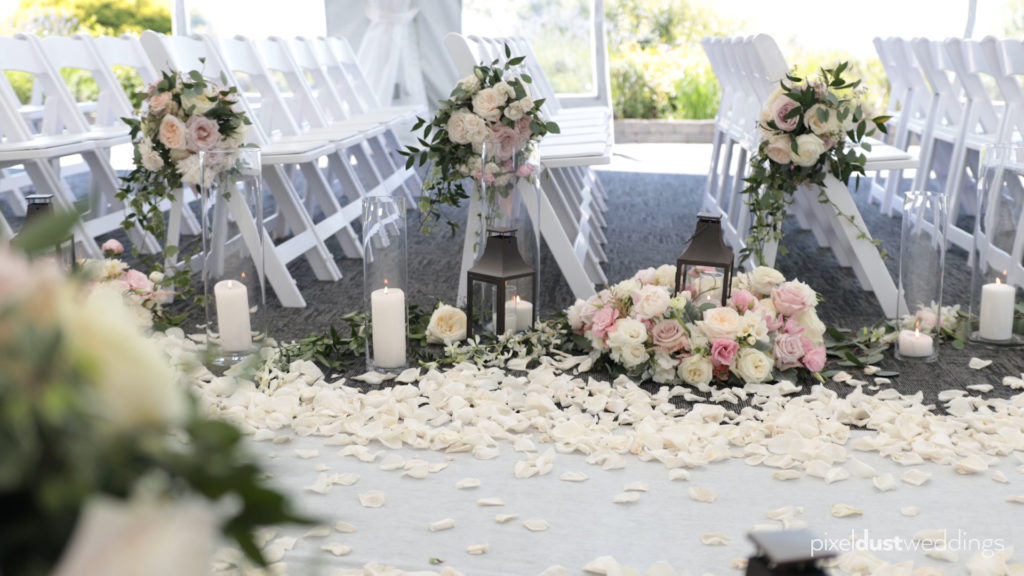 wedding ceremony aisle flower design example. Video still by Seattle's best wedding videographer